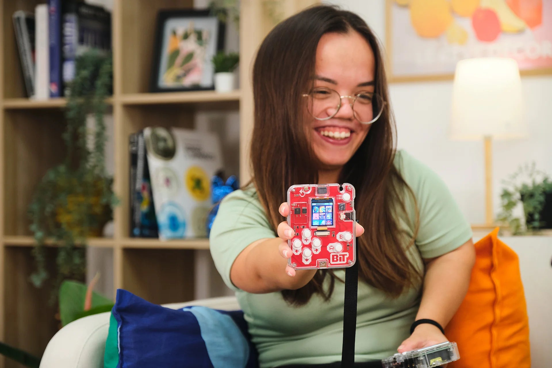 Woman playing with CircuitMess Bit 2.0